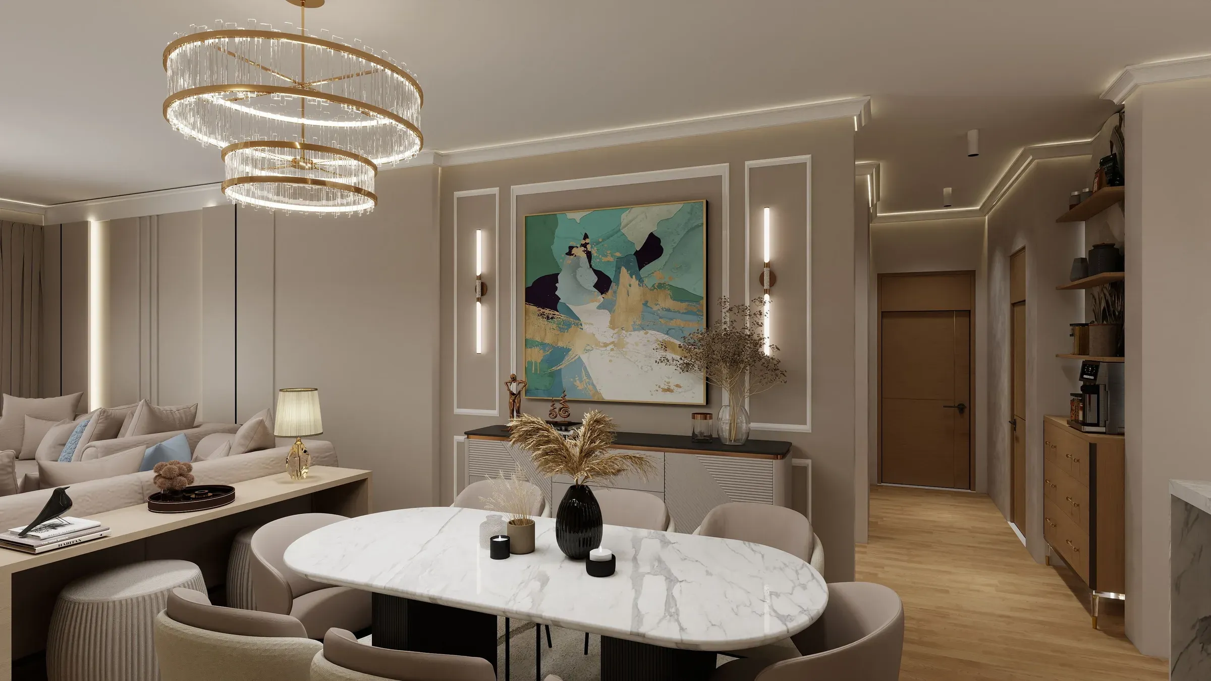 Dining area with an oval marble table, tiered ring chandelier, framed art panel and lit wall mouldings