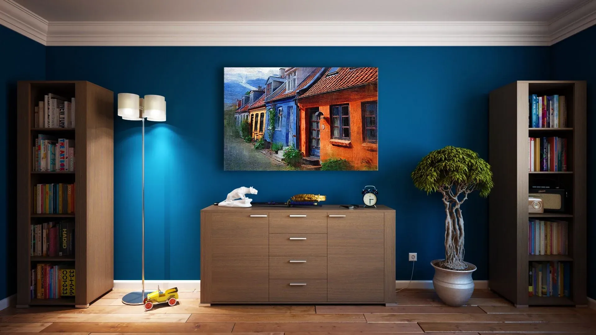 Deep blue wall with a large painting above a wooden sideboard, flanked by bookshelves and a floor lamp